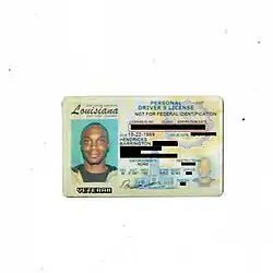 Photo of a Louisiana diver's license, license photo features JPEGMAFIA smiling. The personally identifying information on the license is blocked out by black bars and a text in a pixel-like font displays the word "veteran" under the license photo.