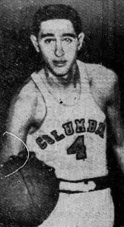 Photo of Jack Molinas from his college basketball tenure at Columbia University holding a basketball at the palm of his left hand.