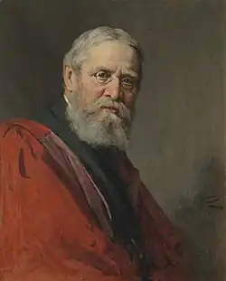 Peile in later life, wearing a scarlet robe and glasses.