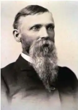 Sepia toned headshot of Prowers with a beard