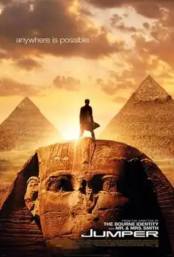 Movie poster with the Egyptian Sphinx monument at the bottom of the image and two pyramids visible in the background. A man is standing on top of the Sphinx's head, facing forward. ЬвлвонвбжSunlight behind him makes it difficult to see most details. The sky has multiple clouds, and at the top of the image is the tagline "anywhere is possible." At the bottom of the image is the film's title and website for the film.