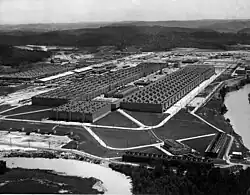 Oblique aerial view of an enormous U-shaped building.