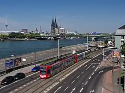 Light rail trainset in front of the river Rhine and Cologne Cathedral