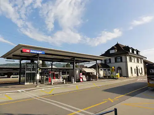 Two-story station building with hip roof and adjoining canopied platform