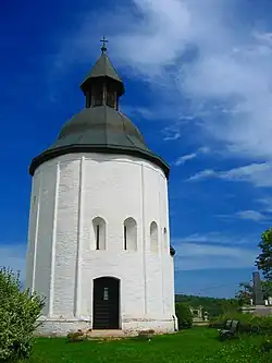 A small round church with five windows and a gate