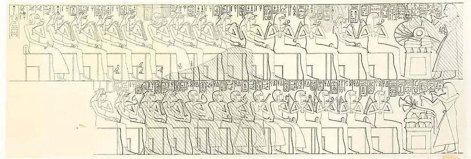 A man depicted twice standing before two rows of seated royalty