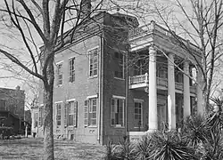 Kirkpatrick mansion on Oak Street, burned in 1935. The two-story brick slave quarters at the rear remains intact.