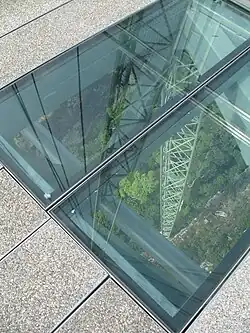 Sections of glass flooring being installed at the bridge