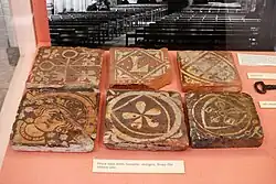 Six decorated medieval terracotta floor tiles, excavated at the abbey