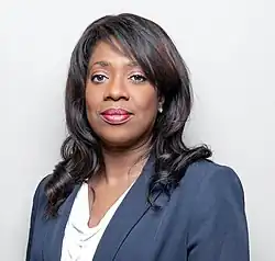 Lewis wearing a dark suit.