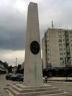 Obelisk near a tall building