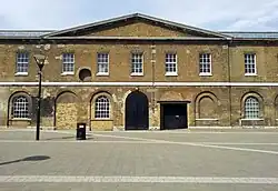 East range; barrels would leave the first-floor by way of the round hole (left)