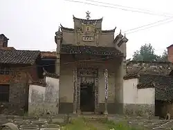 This shrine to a Master Yong in a Yangxin County village, Hubei features a tablet, high in the facade, saying "The Three Stars are Present". The symbol at the top of the facade is a stylised derivation of the character shou , "longevity"