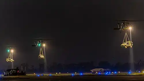 M1301 ISVs being sling-loaded by UH-60 Black Hawks