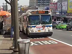 Curbside, red-painted bus lanes on Fordham Road in the Bronx