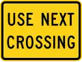 W10-14aP Use next crossing (plaque)