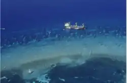 Aerial view of a ship aground on a coral reef