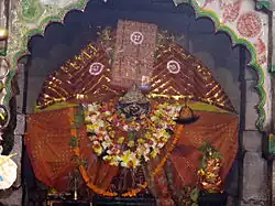 Goddess spearing an animal