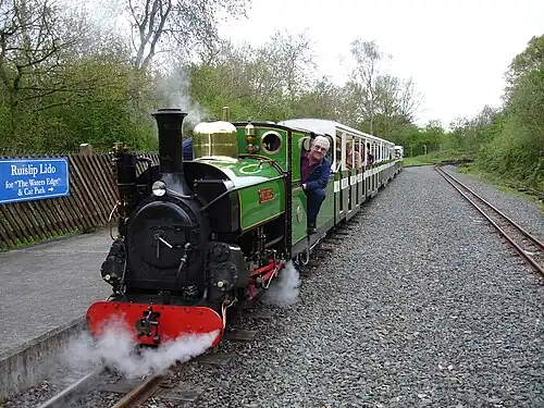Image 37Ruislip Lido Railway's 12-inch (300&nbsp;mm) gauge locomotive "Mad Bess" hauling a passenger train.