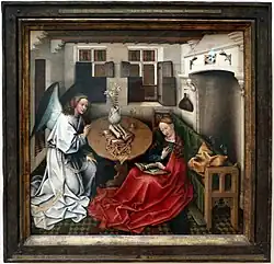 Annunciation by Robert Campin; a wood print is in the top right, between candle fixtures.