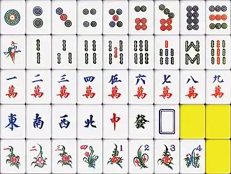 Hand carving tiles in Canton, the bird of one bamboo reflecting the carver's skill.