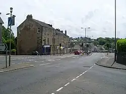 Road junction with view towards three-storey sandstone buildings