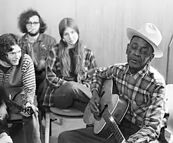 Mance Lipscomb at right with students at guitar workshop, Wisconsin Delta Blues Festival, Beloit, Wisconsin, March, 1970.
