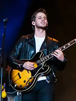 Mark Foster playing a guitar