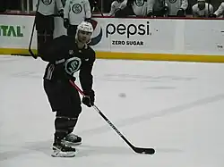 Hockey player skating in blue Seattle Kraken practice jersey