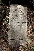 Tombstone with individual holding a duck