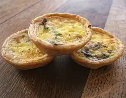 Three small individual quiches with mushrooms and pale custard filling