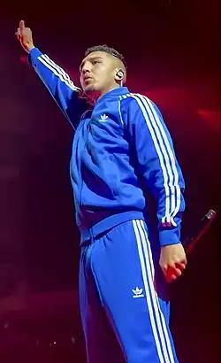 Spanish rapper Morad wearing a tracksuit during a concert