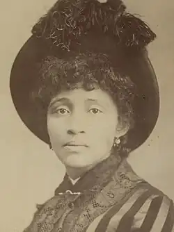 Head and shoulders photograph of Parsons wearing a hat looking into camera