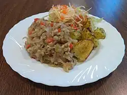 Mulgikapsad (sauerkraut with pork and pearl barley) served with baked potatoes