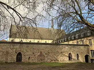 The cloister's south wall still features 13th-century blind windows and arches.