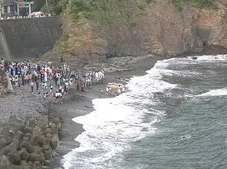 An o-waraji is carried into the sea at a waraji festival, Nakiri-jinja, 2006