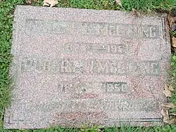 Flat red granite stone inscribed with information of McClung and her husband