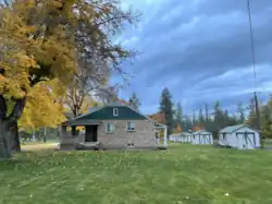 Cottage showing lawn and garages
