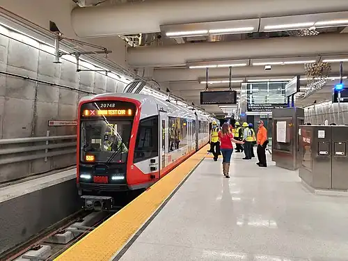 A light rail train at an underground station