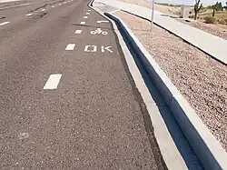 Pavement markings indicate sidewalk riding is legal.