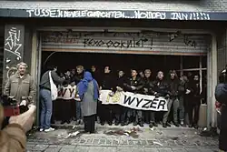 Colour photograph of a crowd of people, mostly young and white, demonstrating against eviction