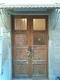 Wooden door entrance to first floor decorated with magen david (star of David) and the word Zion in Hebrew.