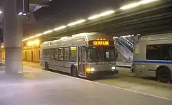 A silver-painted trolleybus at an underground station
