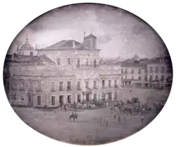 Photograph showing the Imperial Palace in Rio de Janeiro with carriages and mounted honor guard in the square fronting the palace