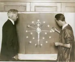 Paul Hadley (left) with the flag that was given to the state, 1923.