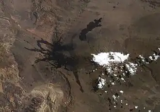 Black tongue-like lava flows spreading radially
