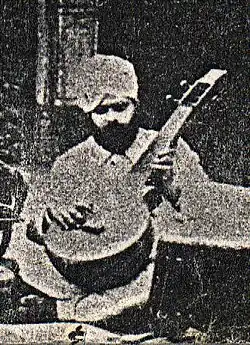 Photograph of a rababi of Nabha state holding a seni rebab, late 19th or early 20th century.