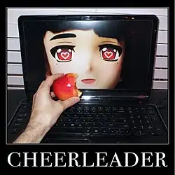 In a desk, a laptop shows an image of a person wearing a mask with hearts in its eyes with another person holding a bitten apple in front of the laptop.