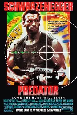 A muscular soldier holds an M16 rifle. The foreground has the crosshair of a gun's sight centered on the man's heart. The background is in the style of a brightly colored thermal map. The name Schwarzenegger is in large red letters at the top of the poster and the film title is in the same size and below the picture.