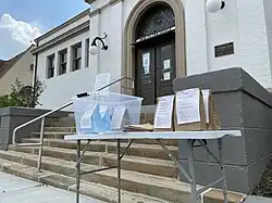 Children's programming kits being displayed and offered on the sidewalk in front of the Mt. Washington branch